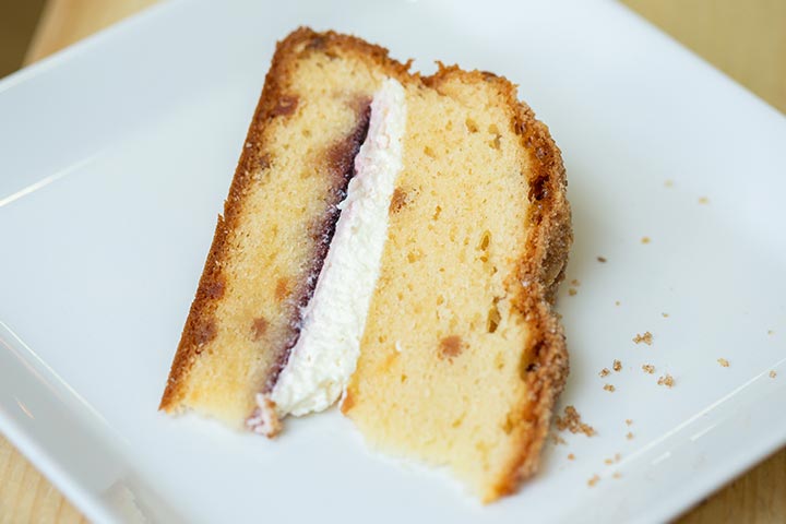 A slice of cake on a white plate.