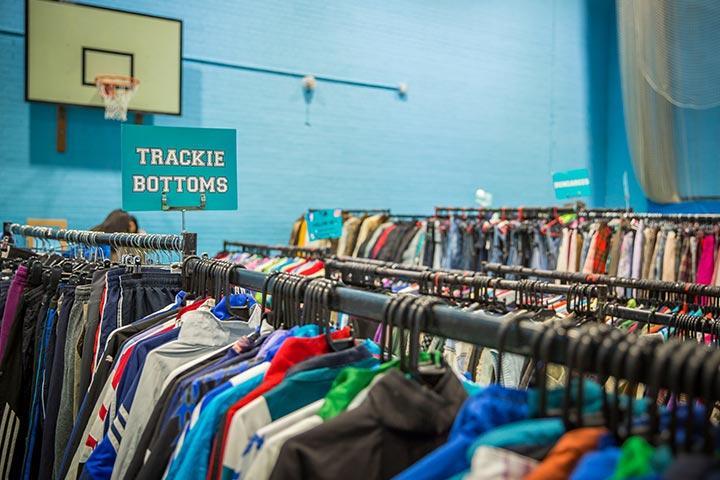 Rails of clothing in the Sports Hall, University of Bradford.