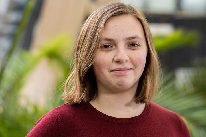 A student smiling at the camera