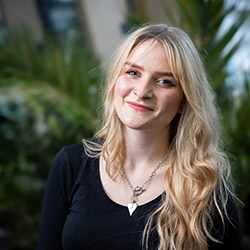 A student smiling at the camera