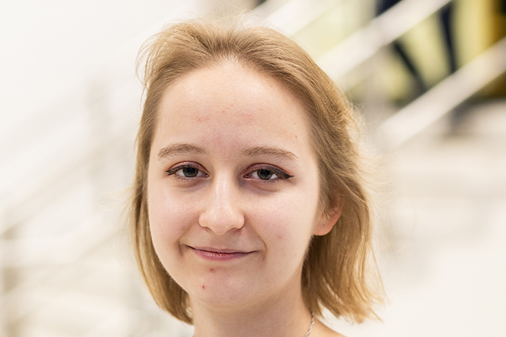 A student smiling at the camera