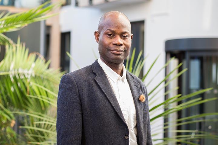 MBA Student Akpobibibo Onduku standing in the Bright Building.