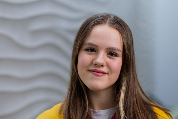 A student smiling at the camera