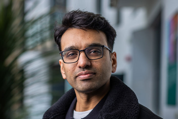 A student looking at the camera with a thoughtful expression