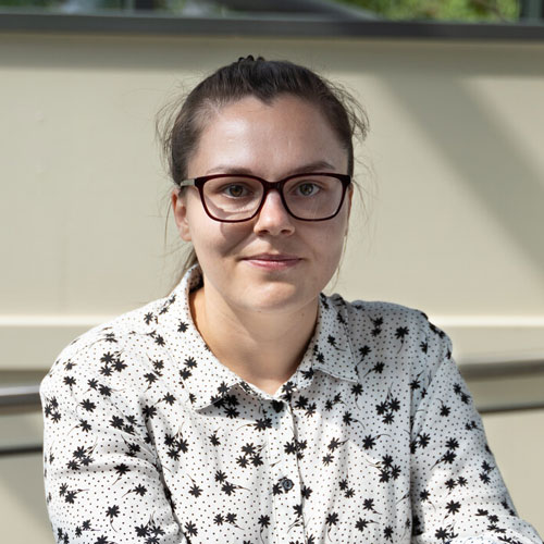 A head and shoulders photo of a person smiling at the camera.