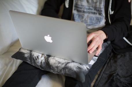 A student typing on a laptop