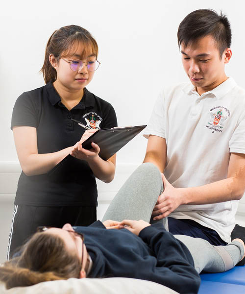 A physiotherapist applying pressure to a client