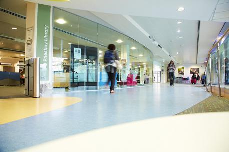 A student walking outside library