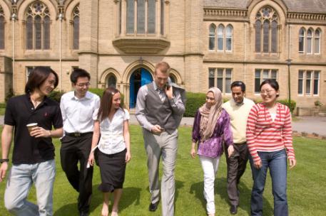 Group of students walking in front of University campus facility