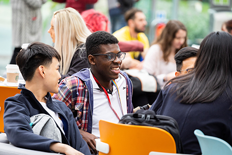 Students smiling in the atrium