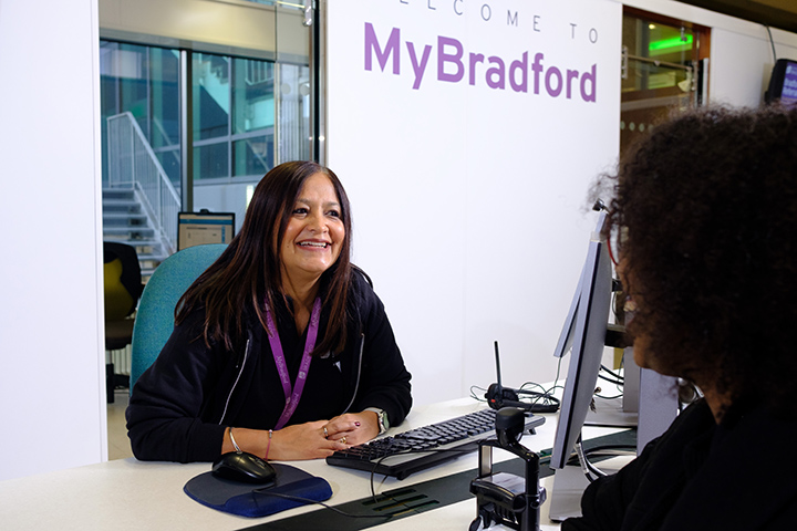 A member of the MyBradford team smiling at a student