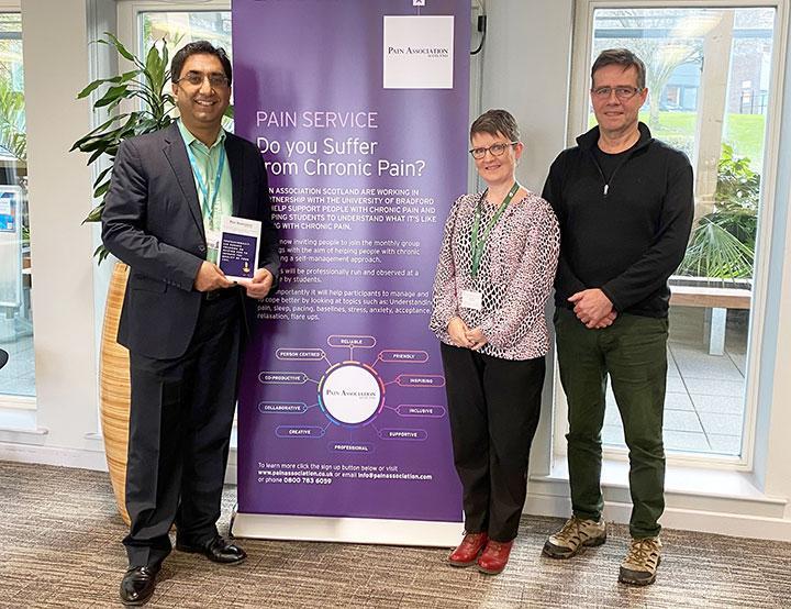 Amir Sharif, Sonia Cottom and Phil Sizer with the Pain Clinic banner