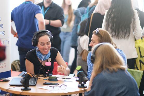 A group of women sat around a table on the radio