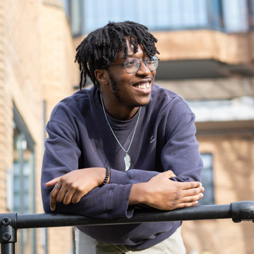 Undergraduate student wearing glasses smiling