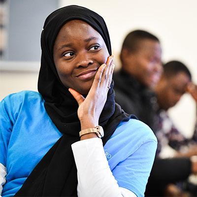 Student smiling, looking away from camera.