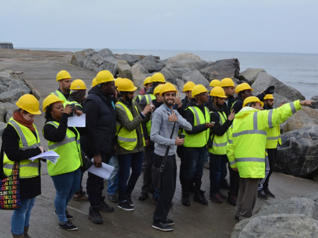 Students wearing high-vis jackets and hard hats in Whitby.