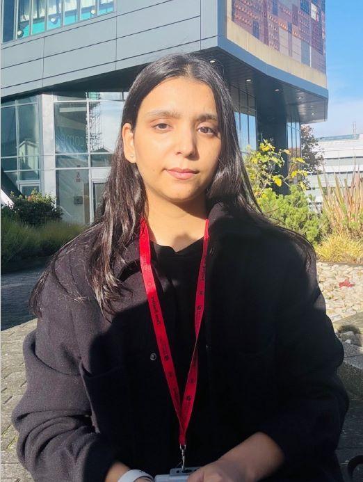 A Student Event Coordinator sitting outside