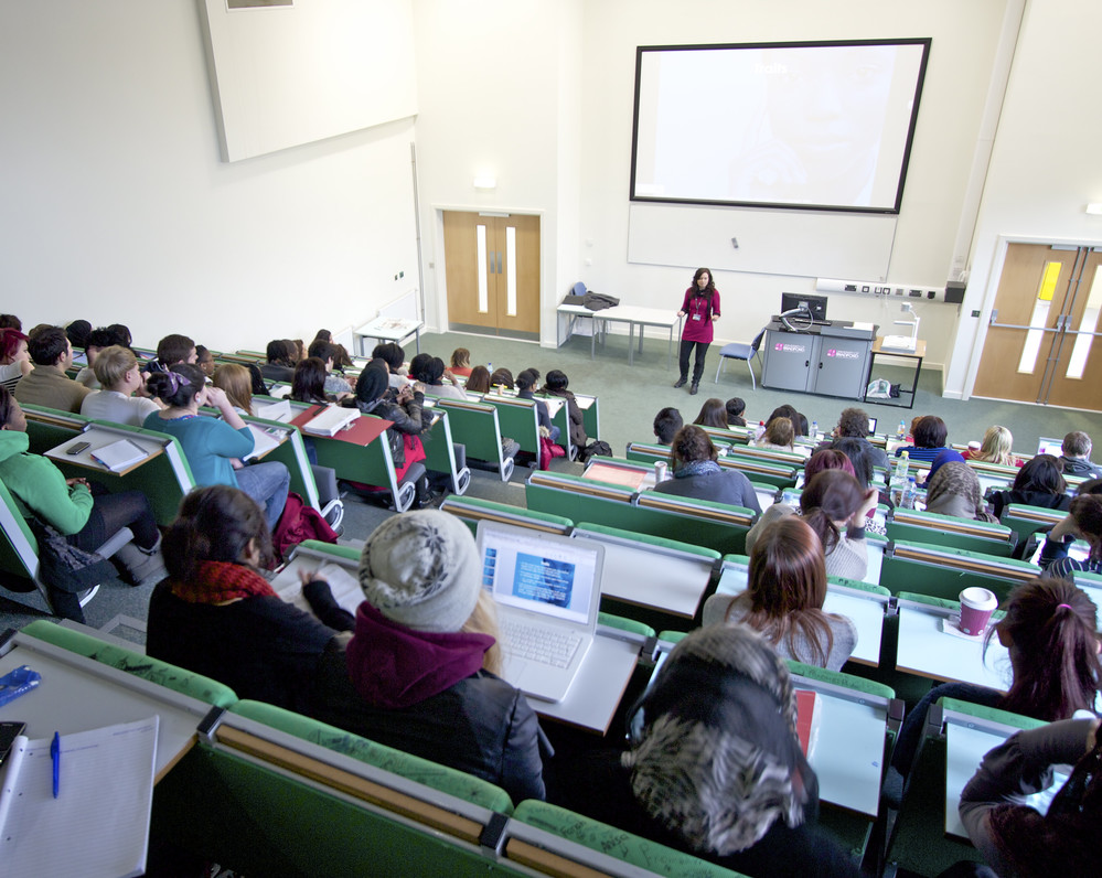 Students sat in a lecture theatre.