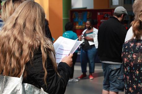 An Open Day attendee reading the Open Day guide.