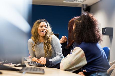 Three students chatting in a seminar