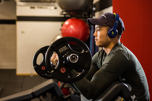 A student lifting weights at the University gym