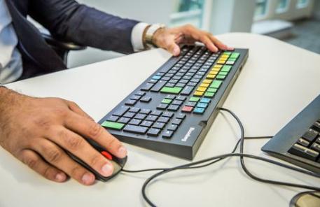 Office worker types on a computer keyboard