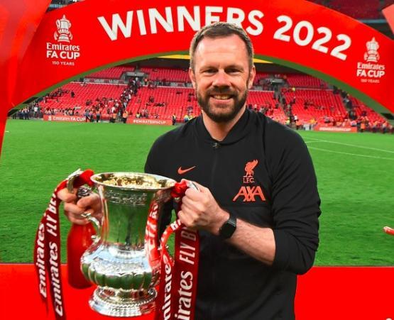 Liverpool FC head physio Chris Morgan holding FA Cup