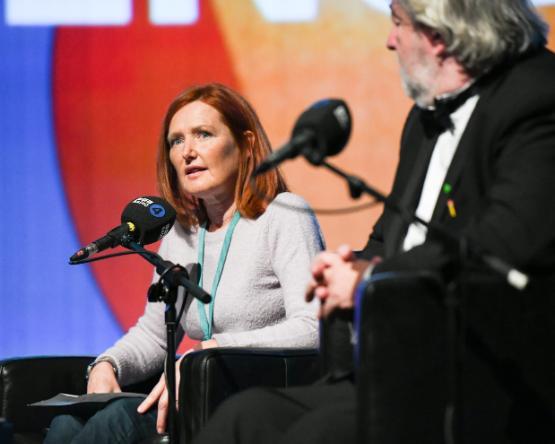 Dr Karen Thornton sitting in front of a microphone