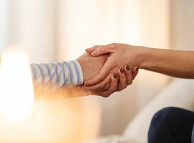 close up on two people holding hands