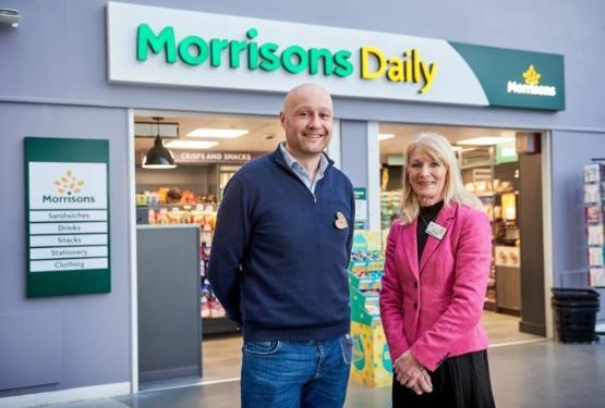 two people stood outside shop