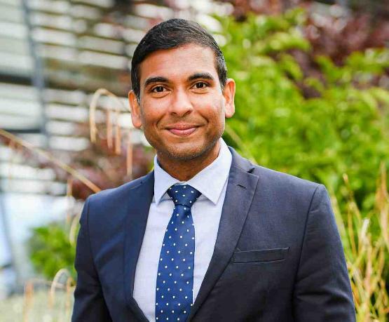 Staff member in suit smiling for camera