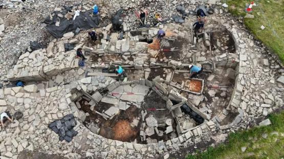 A group of people taking part in an archaeological dig