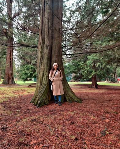 Krupa Sayania standing next to a tree