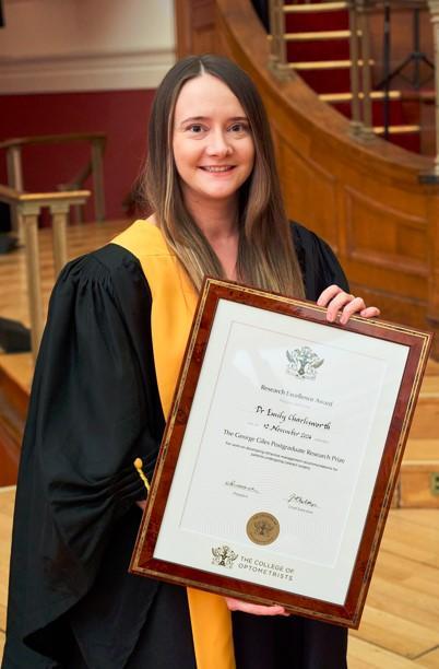 PhD Emily Charlesworth holding her award