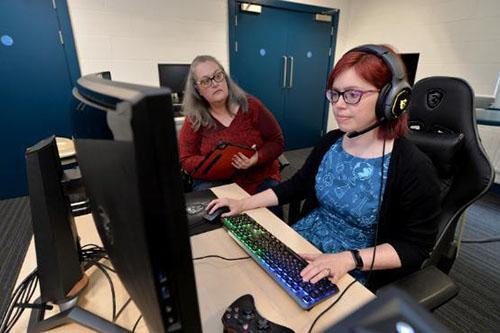 Woman demonstrating the use of the curved gaming screen