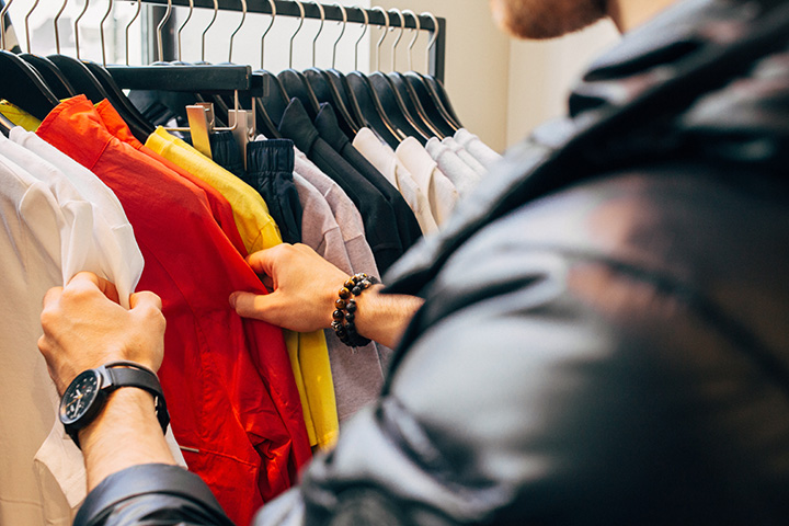 Person looking through clothes on a rack