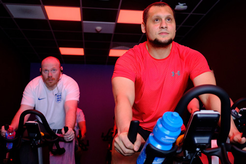 Two people on stationary bikes.