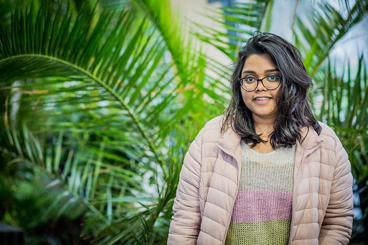 MSc International Strategic Marketing student Sravani Karnam in front of plants in the Bright Building