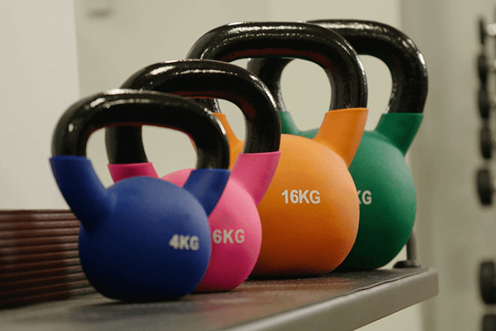 Row of colourful kettlebells 