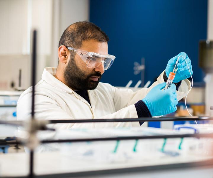 A chemistry student working in a laboratory.