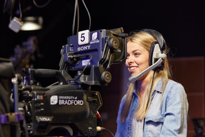 A student using a camera. 