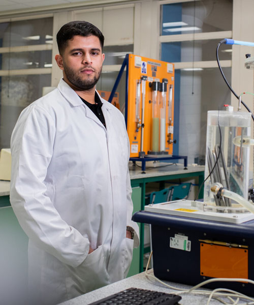 A postgraduate student in a chemical engineering lab