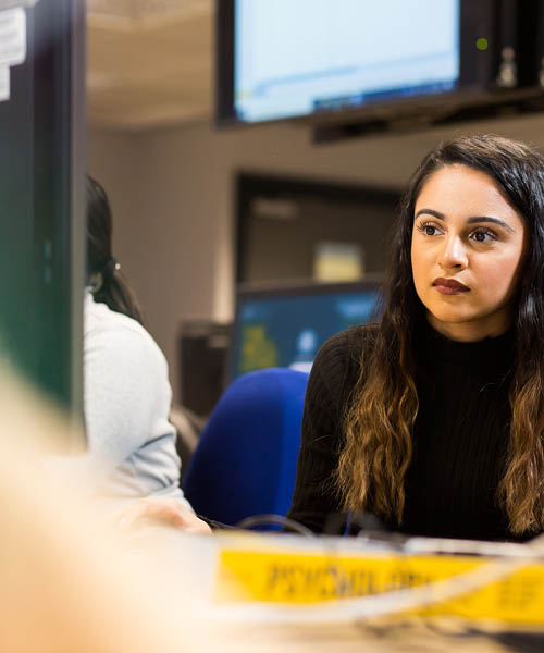 Psychology student looking at a desktop computer.