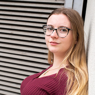 A student smiling at the camera