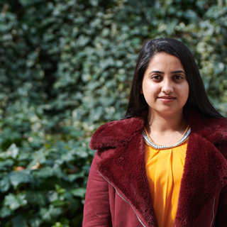 Ifrah, Law student, posing in front of the Broadway Bradford.