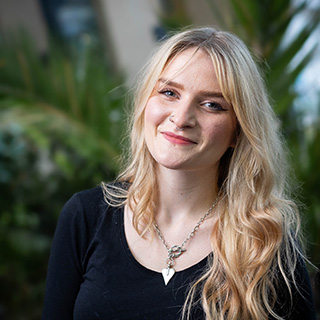 A student smiling at the camera