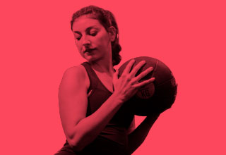 Woman holding medicine ball. 